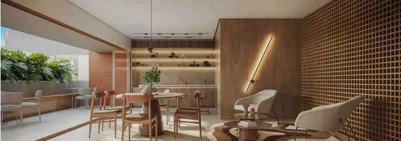 Lounge gourmet do Soul Rio Gago Coutinho com mesa de jantar e painel vazado
